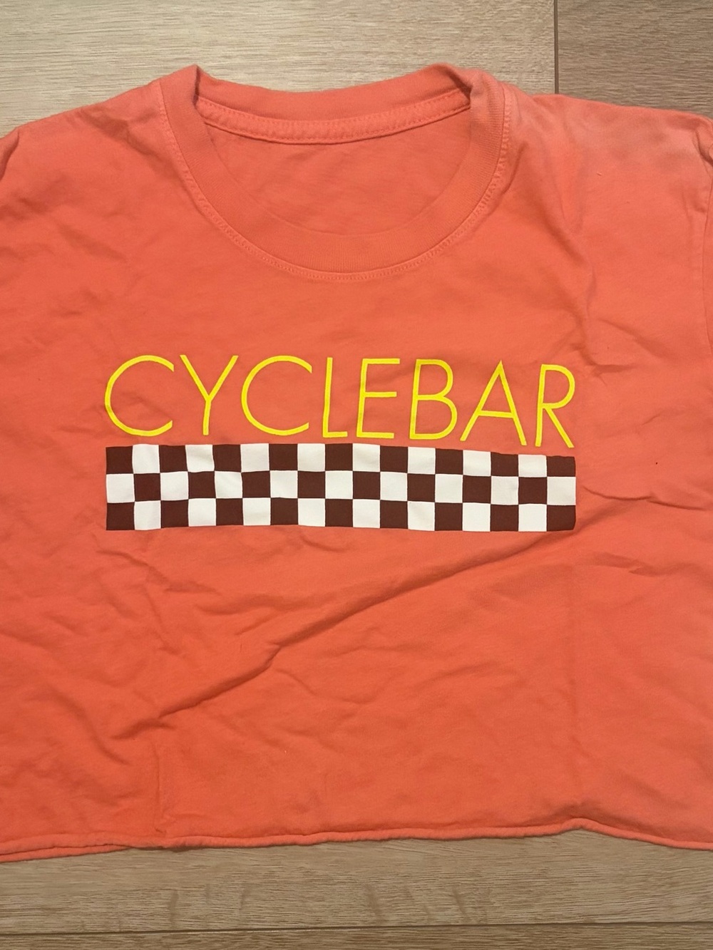 Cyclebar Kids Orange Tee with Yellow Logo and Brown Checkered Stripe